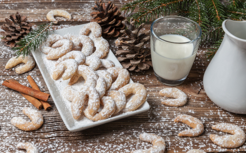 Vanille cookies and milk on a wooden table